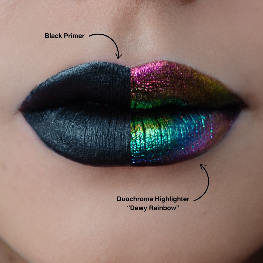 Lip swatch split look: matte black primer on the left half and pink, green and gold duochrome highlighter layered over primer on the right.