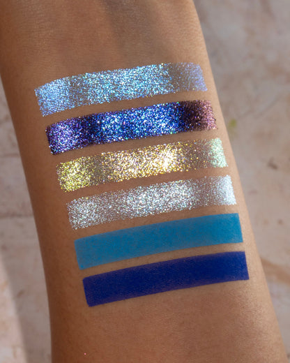 On Cloud 9 shades swatched, silver, teal, and cobalt blues on skin