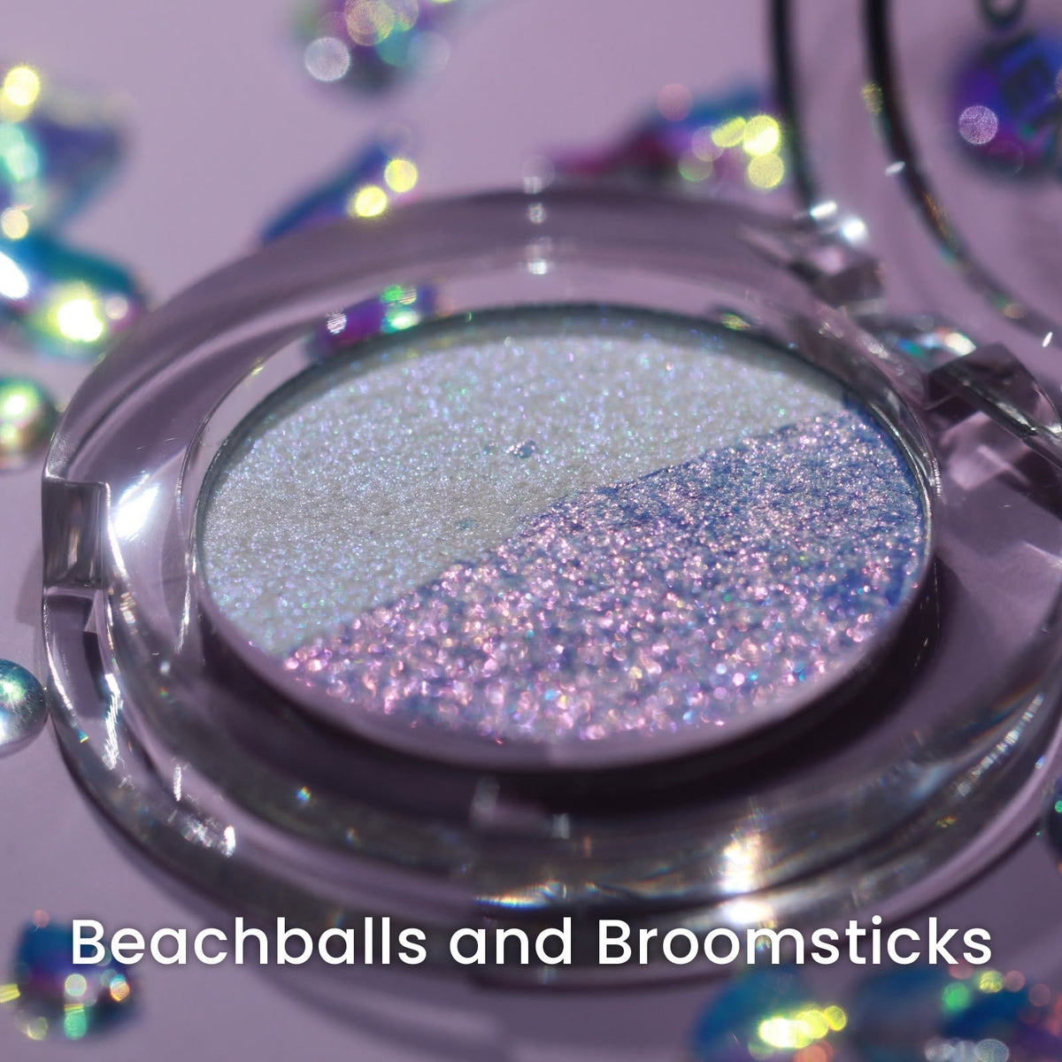 The Beachballs and Broomsticks compact open on lilac with iridescent confetti, split pale and pink-purple.