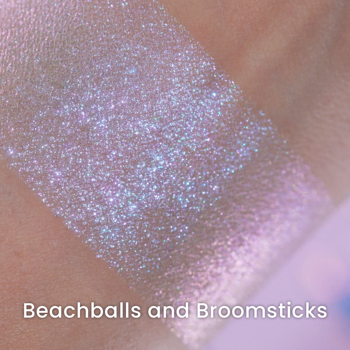 Macro of a blended Beachballs and Broomsticks swatch, lilac and blue sparkle over a warm base.