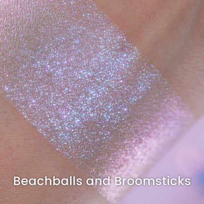 Macro of a blended Beachballs and Broomsticks swatch, lilac and blue sparkle over a warm base.
