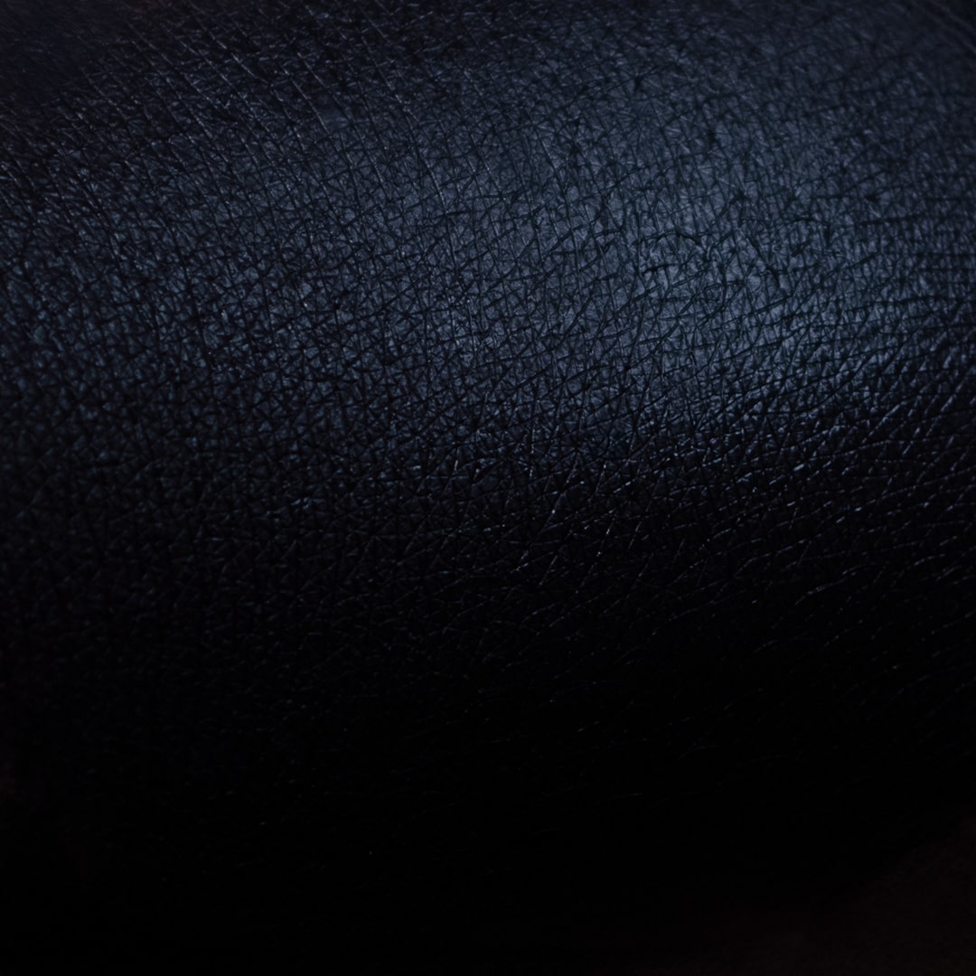 Black primer swatch blended across light skin, showing an opaque, slightly satin black finish.