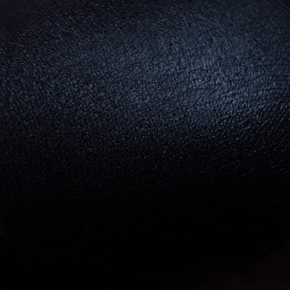Black primer swatch blended across light skin, showing an opaque, slightly satin black finish.