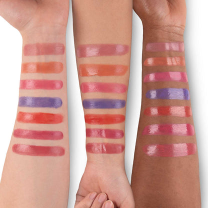 All seven Dew Drip liquid blush shades swatched in rows across three arms of different skin tones