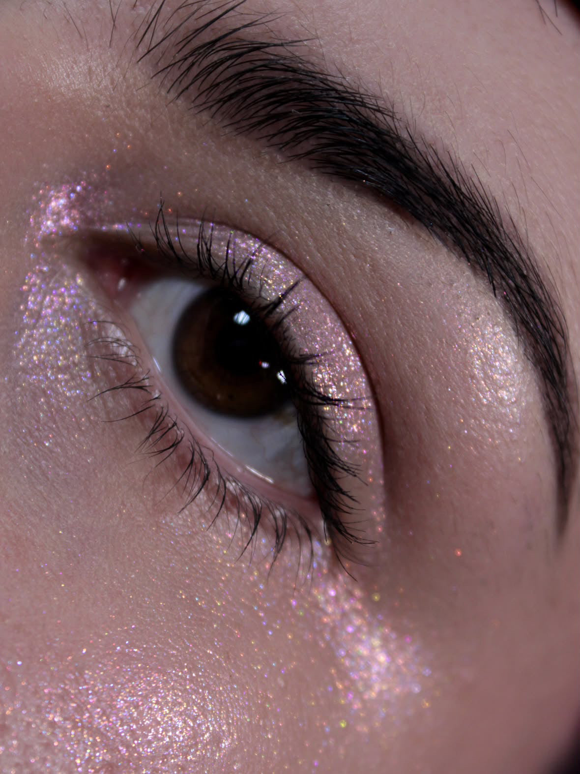 Eye close-up with the highlighter on the brow bone, inner corner and cheekbone.
