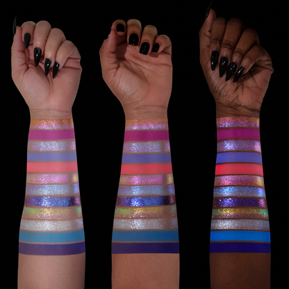 On Cloud 9 shades swatched on three skin tones, pastel blue, purple, coral, and silver shimmers with matte accents