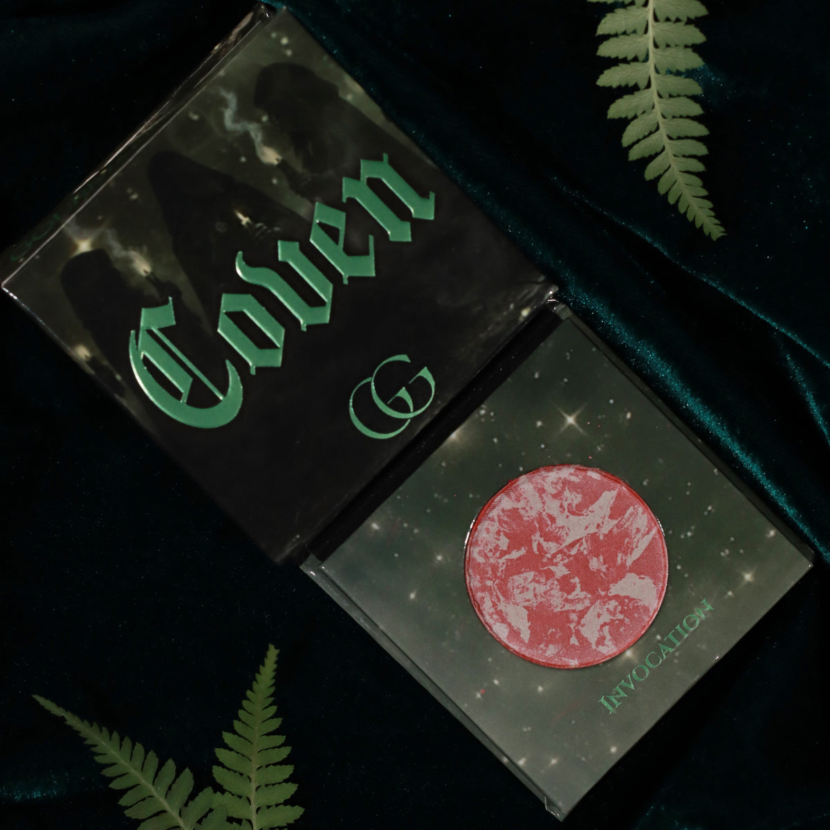 Gourmande Girls Coven blush in Invocation, a rose pink and pale pink marbled pan in a green starry compact beside the Coven box
