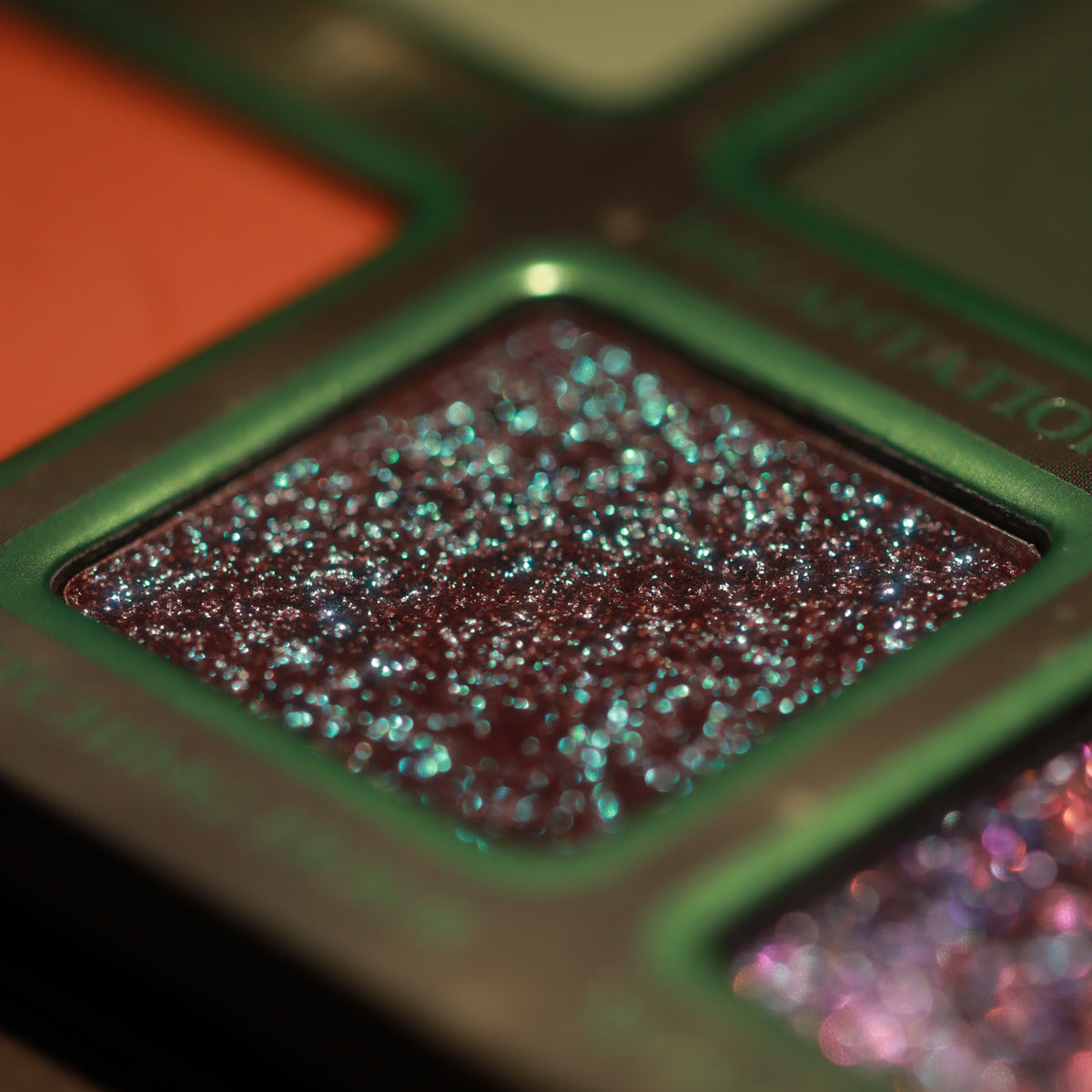 Macro of Witching Hour, a dark pan scattered with teal sparkles
