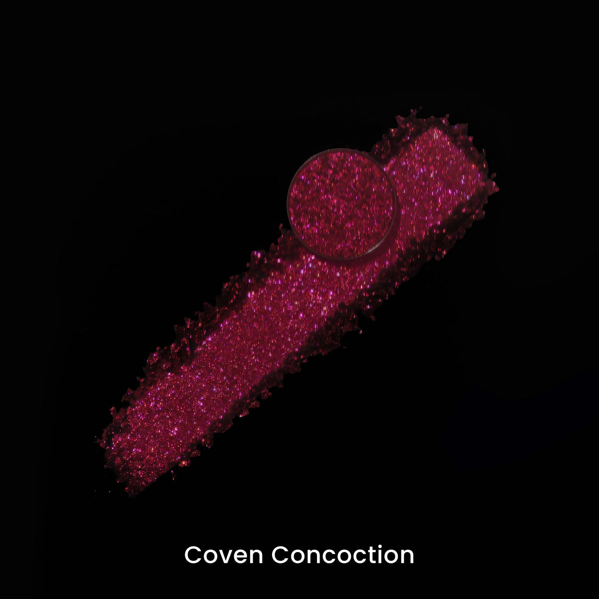 Coven Concoction pan on a smear of the red pigment, on black.