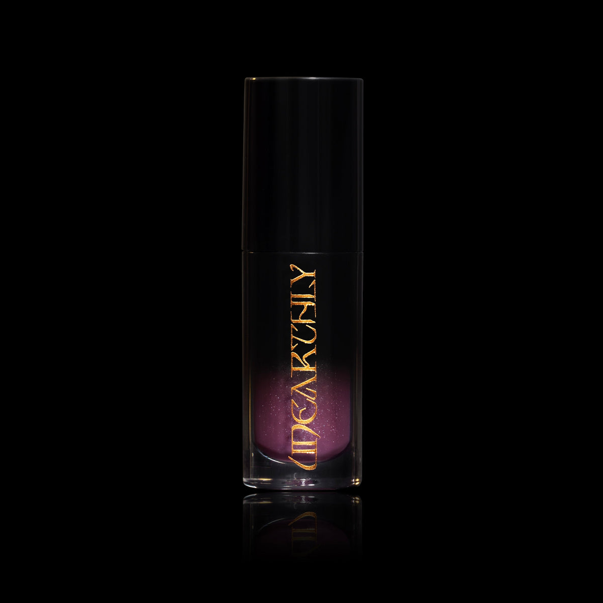 Crystal Ball in a clear tube with a black cap and gold Unearthly logo, smoky purple gloss with sparkle showing through