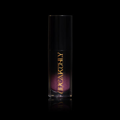 Crystal Ball in a clear tube with a black cap and gold Unearthly logo, smoky purple gloss with sparkle showing through