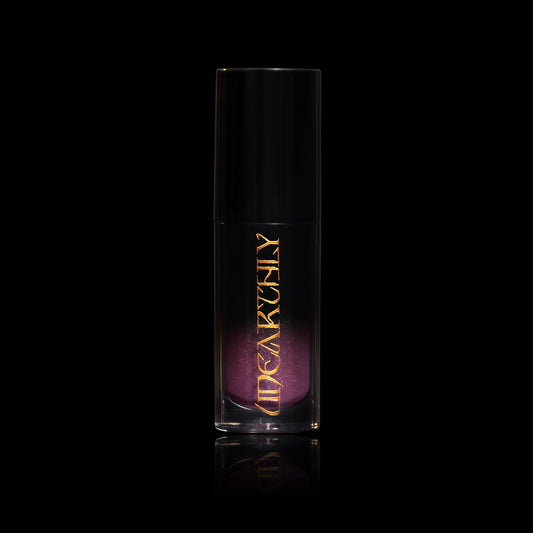 Crystal Ball in a clear tube with a black cap and gold Unearthly logo, smoky purple gloss with sparkle showing through