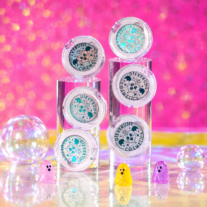 The six Sporkleween singles closed and stacked on clear risers with small ghost figures, from the brand's bundle page