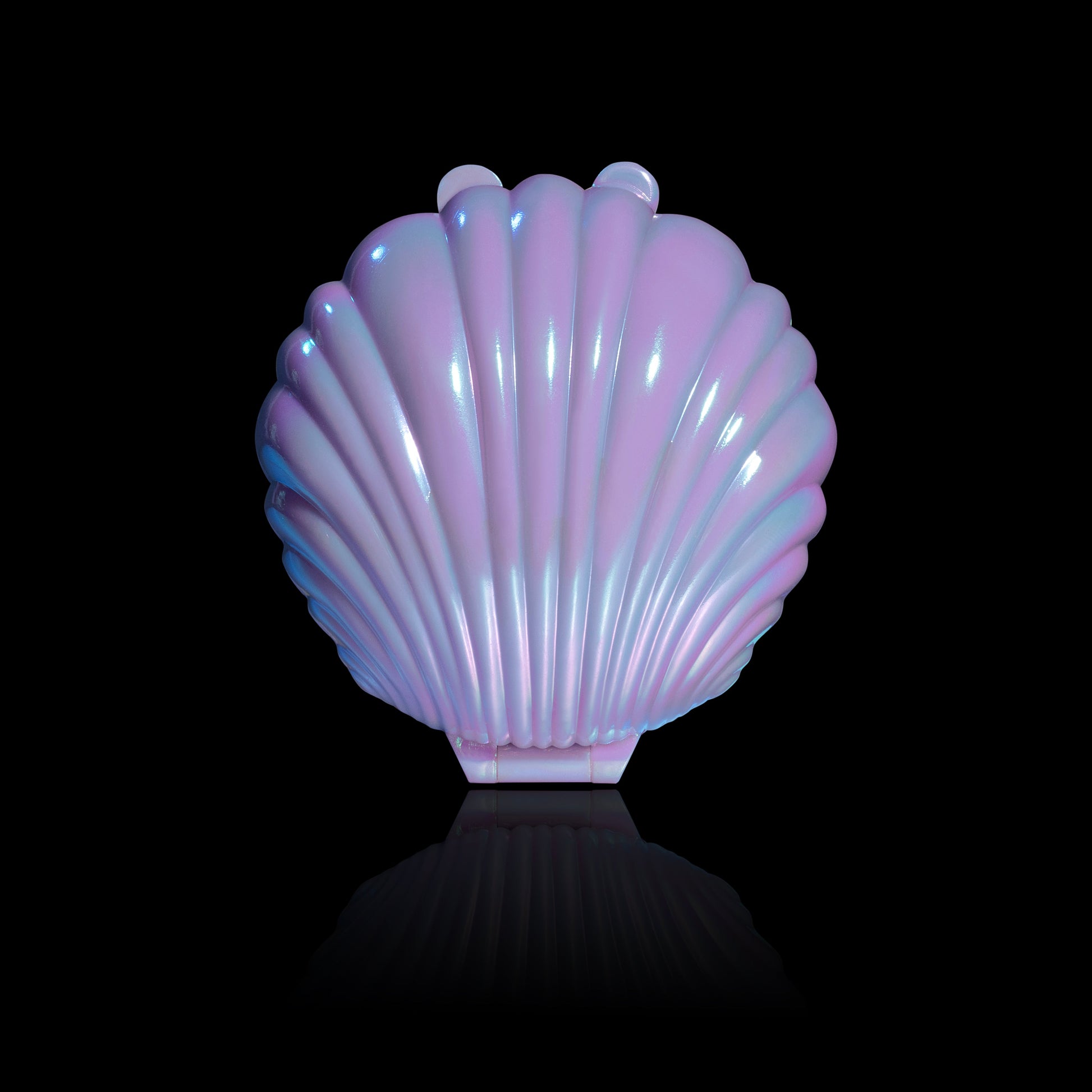 Dewlight glow closed in an iridescent pink seashell compact