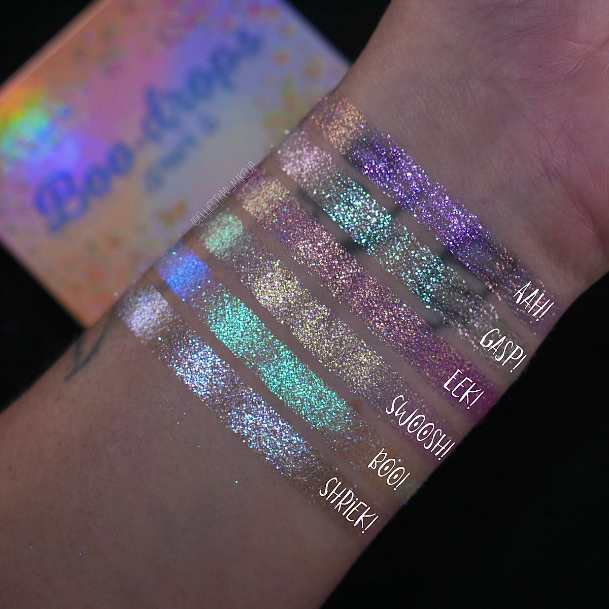 Six arm swatches on light skin beside the closed palette, labelled Aah!, Gasp!, Eeek!, Swoosh!, Boo! and Shriek! against a dark background.
