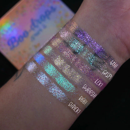 Six arm swatches on light skin beside the closed palette, labelled Aah!, Gasp!, Eeek!, Swoosh!, Boo! and Shriek! against a dark background.
