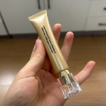 Back of the gold Lock in Glow shimmer base tube held in hand, showing the product description text