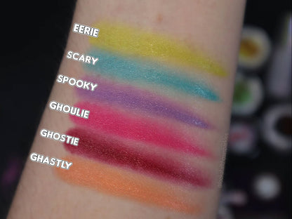 Six thin labelled arm swatches on light skin against a dark background, Eerie down to Ghastly.