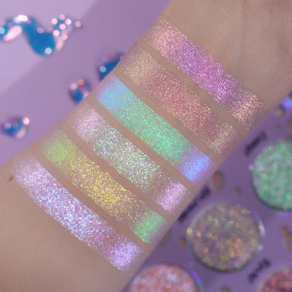 Unlabelled arm swatches on light skin against a lilac background, with three of the palette pans visible at the right.