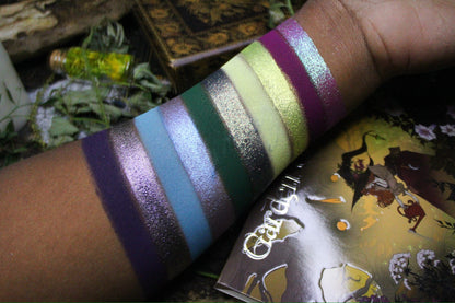 Swatches of the other ten shades on deep skin, with the palette cover in frame.