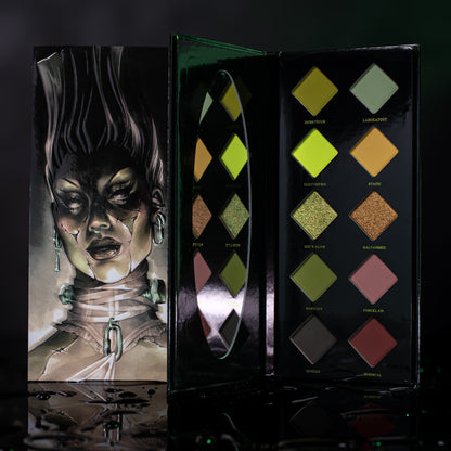 She's Alive mini palette open, ten diamond pans of greens, mustard and browns with olive and bronze shimmers, Frankenstein lid art beside it.