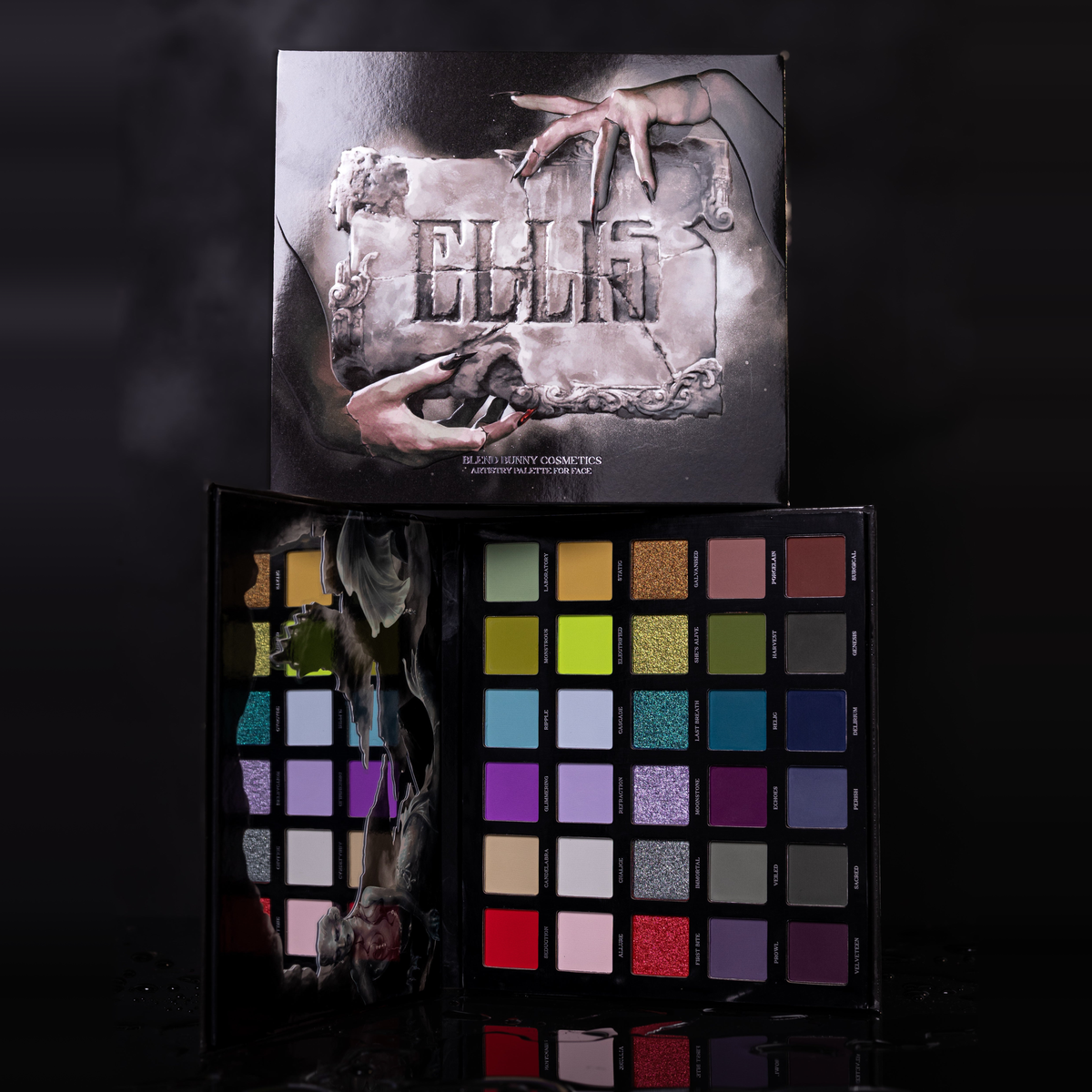 Ellis V3 palette open on a black set with the closed lid standing behind it, the 30 pans turned on their side.
