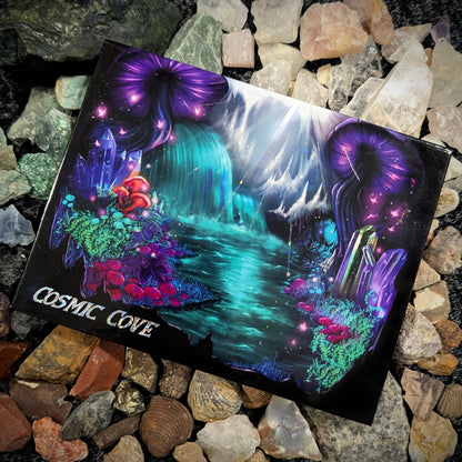 Cosmic Cove closed palette on a bed of multicoloured rocks and crystals, cover art shows purple jellyfish, teal waterfall, mushrooms, and coral