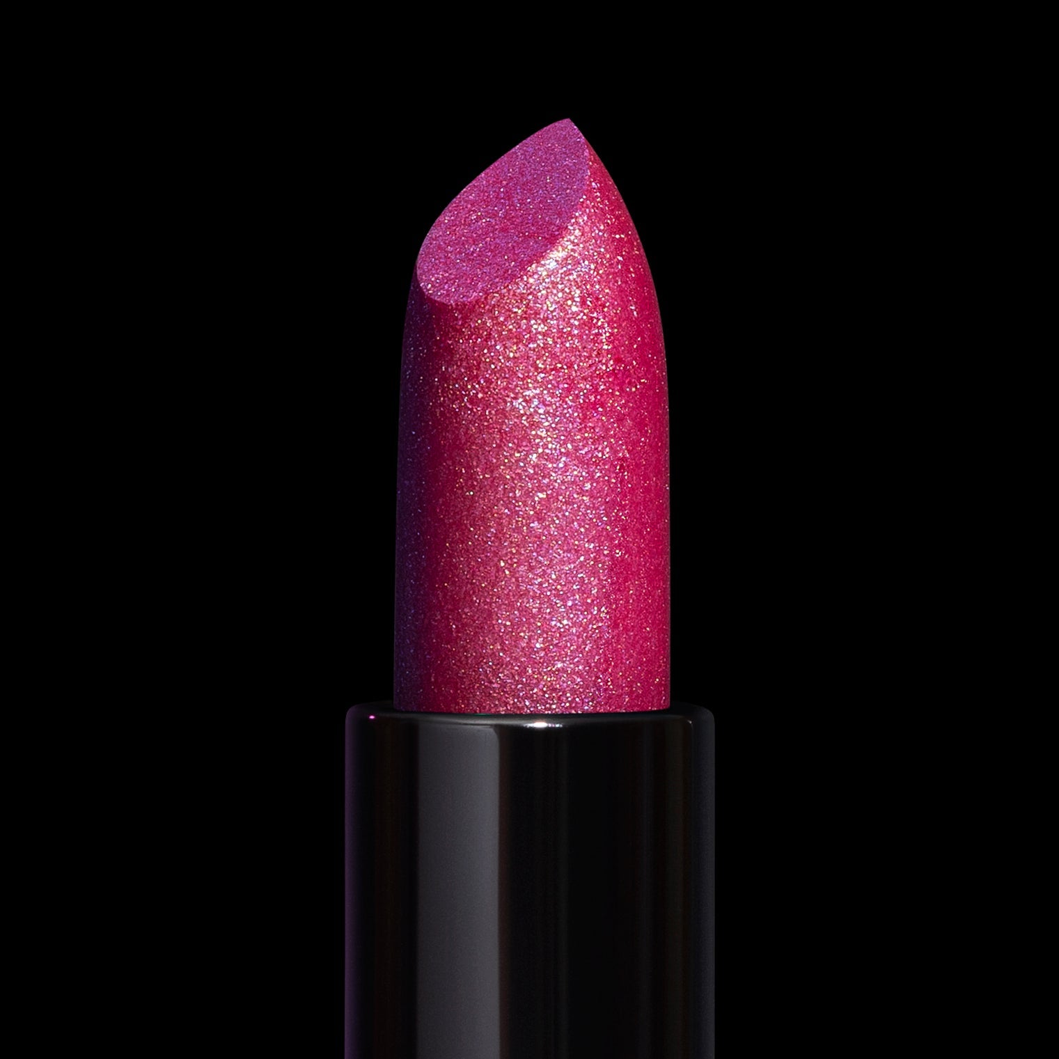 Siren Song lipstick bullet close-up: sparkling fuchsia pink packed with fine multicoloured shimmer