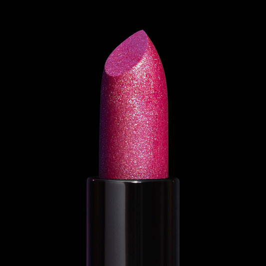 Siren Song lipstick bullet close-up: sparkling fuchsia pink packed with fine multicoloured shimmer