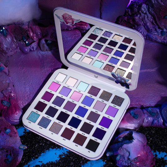 Gleam x Gloom palette open on a purple styled set, pan grid and mirror lit from the side.