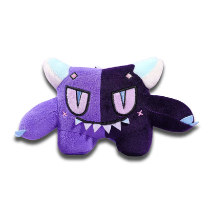 Gloom plush keychain from the front, a two-tone purple critter with pale blue horns, a fanged grin and short wings.