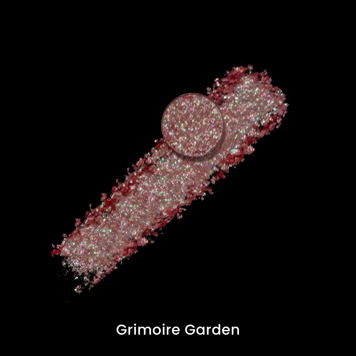 Grimoire Garden pan on a smear of the pale sparkling pigment, on black.