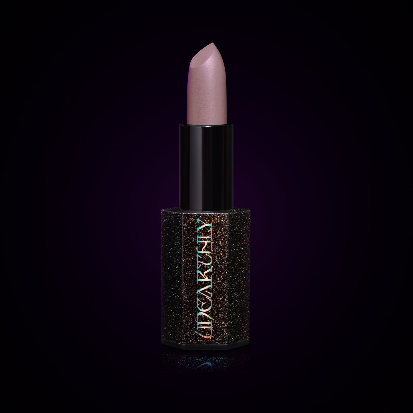 Ghost Milk lipstick bullet, pale lavender-grey cream in a black holographic-speckled tube on a dark background