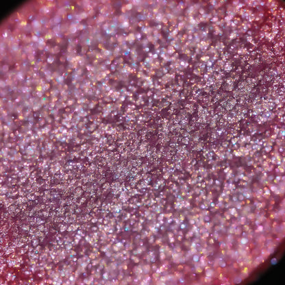 Macro of the pan surface: pink with multicoloured sparkle.