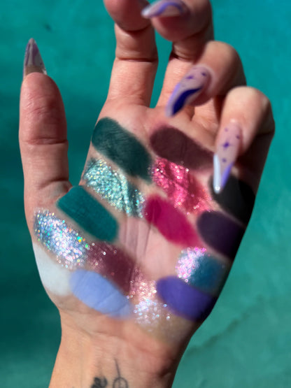 Succulent Dew shades finger-swatched across a palm against a teal background, greens, aqua sparkles, magenta, and lavender
