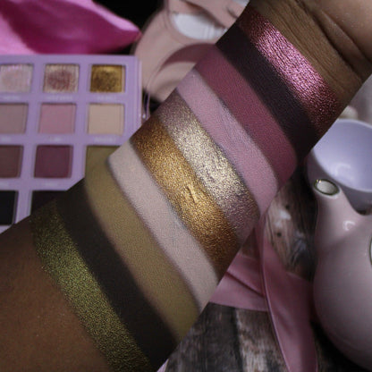 Arm swatches of Dollhouse shades on deep skin: olive and gold shimmers, pinks, and berry tones