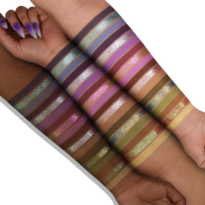 Lavender Fields palette swatches on two skin tones, 18 stripes from lilac and violet to green, gold, and silver shimmer over matte purples and neutrals
