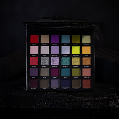 The 30 Ellis V3 pans in five rows of six, lit low on a dark rock set, the row of six shimmers across the middle.