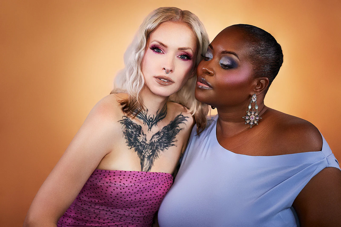 Two models, one light and one deep skin tone, wearing Succulent Dew eye looks together against an amber backdrop