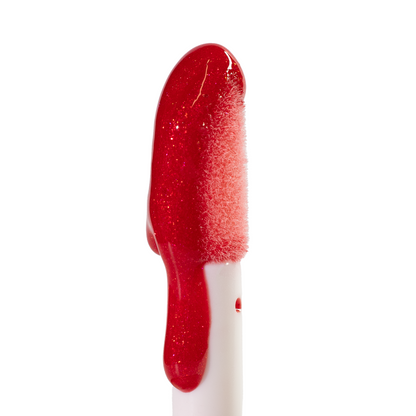 Doe-foot applicator coated in the glossy red Embered lip oil