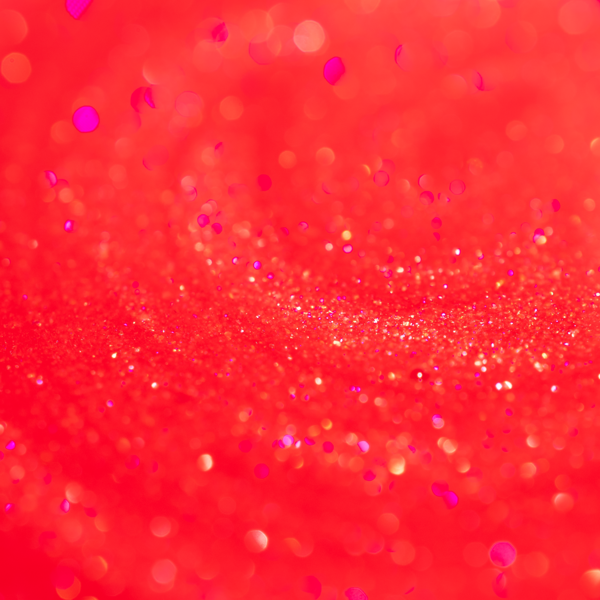 Close-up of the Embered lip oil, sheer red with fine gold and pink sparkle