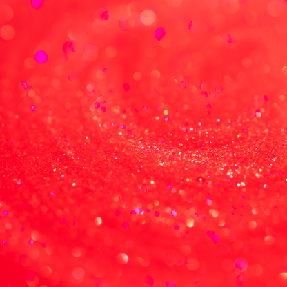 Close-up of the Embered lip oil, sheer red with fine gold and pink sparkle