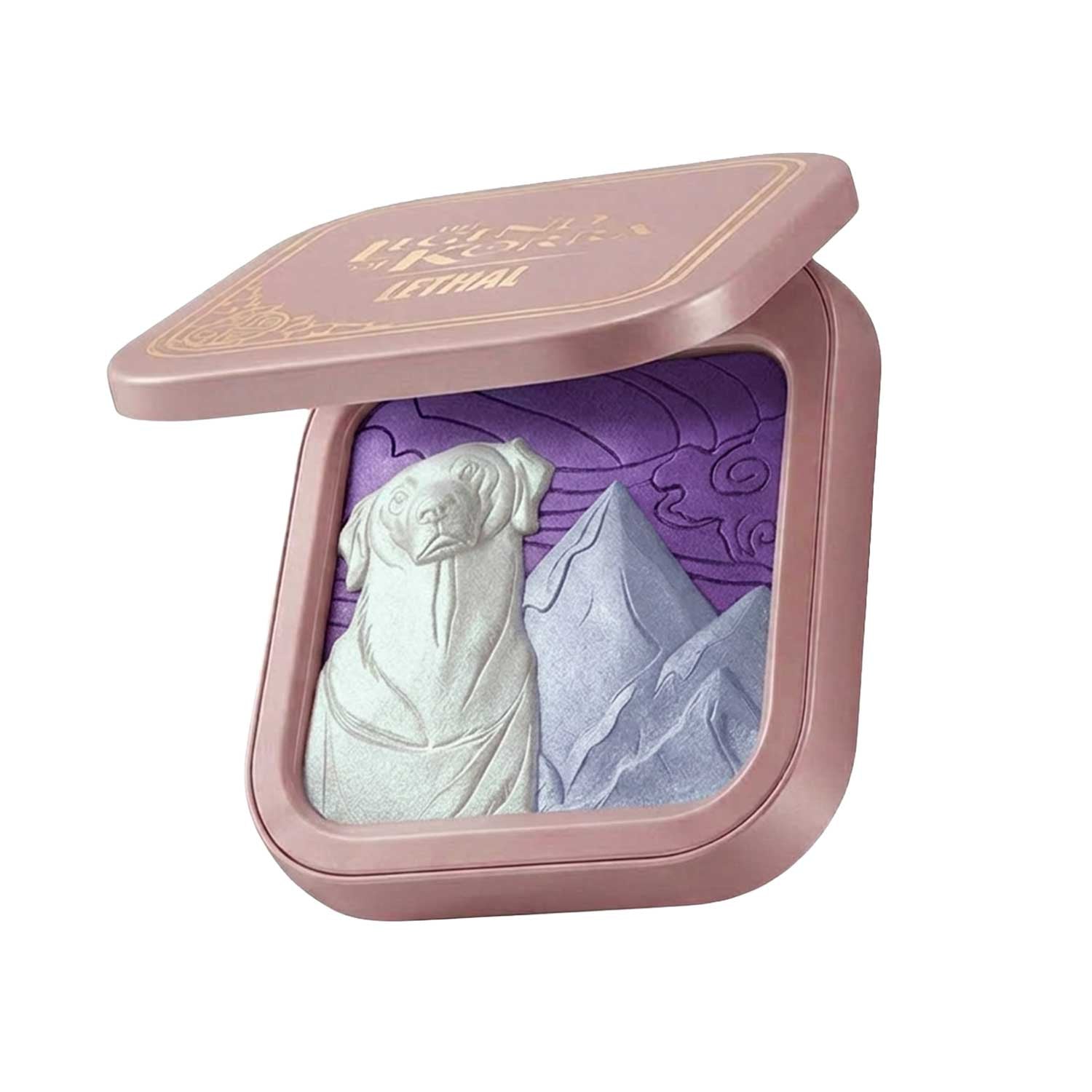 Angled view of the open dusty pink compact, showing the embossed pan in white, icy blue and purple beneath a gold foil Legend of Korra lid