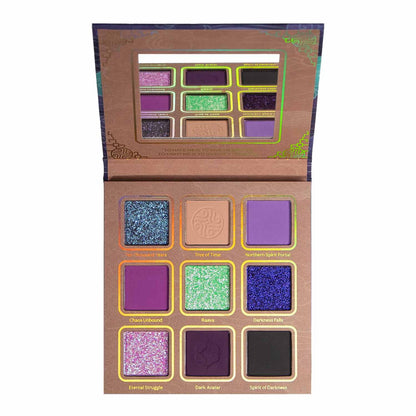 Vaatu palette open top-down, nine pans of teal and green glitters, a lilac duochrome, magenta, deep purples, and black
