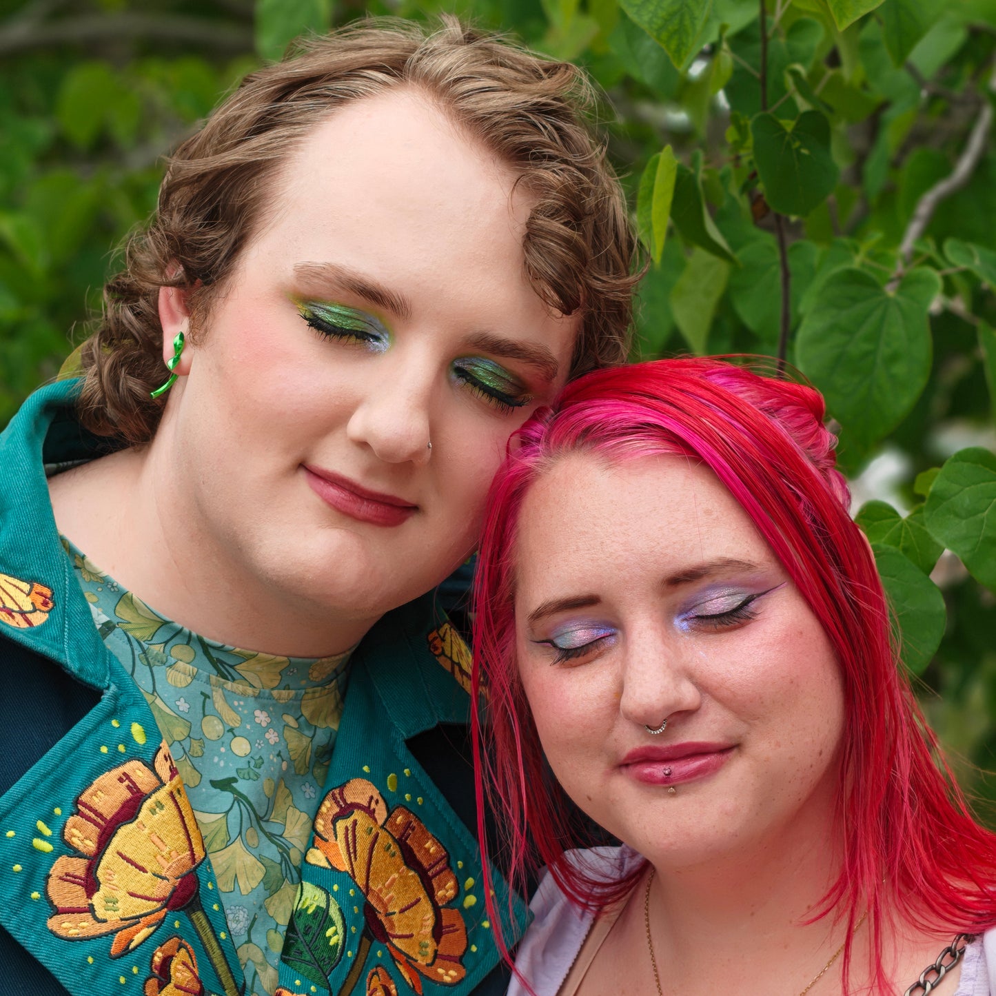 Miles of Multichromatica and his sister wearing Cosmic Cove looks, Miles in a green and teal eye, his sister in a lavender and blue eye, outdoors in foliage