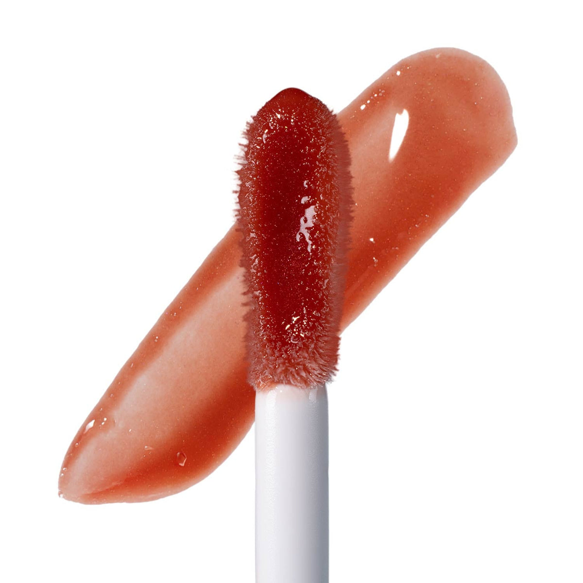 Doe-foot applicator over a glossy red-brown swatch stroke
