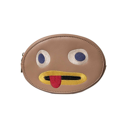 Lethal Over the Garden Wall makeup bag, an oval tan faux leather Rock with embroidered eyes and a tongue-out mouth
