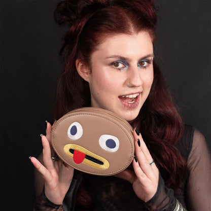 Model holding the Rock makeup bag up beside her face