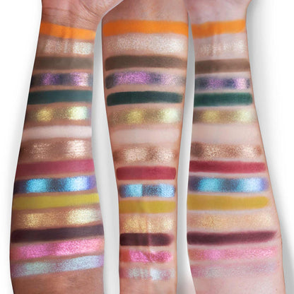 Palette swatched on three skin tones: orange, browns, greens, purples, pinks, blues and gold in horizontal stripes
