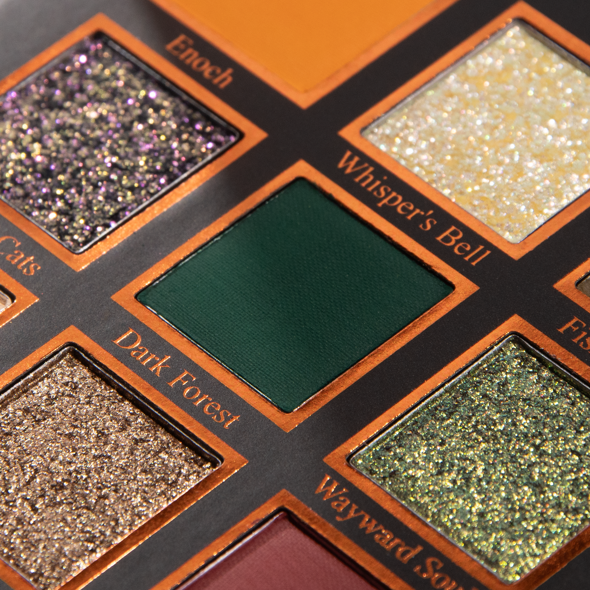 Macro of pans labelled Enoch, Whisper's Bell, Dark Forest and Wayward Souls: sparkle shades beside a deep forest green